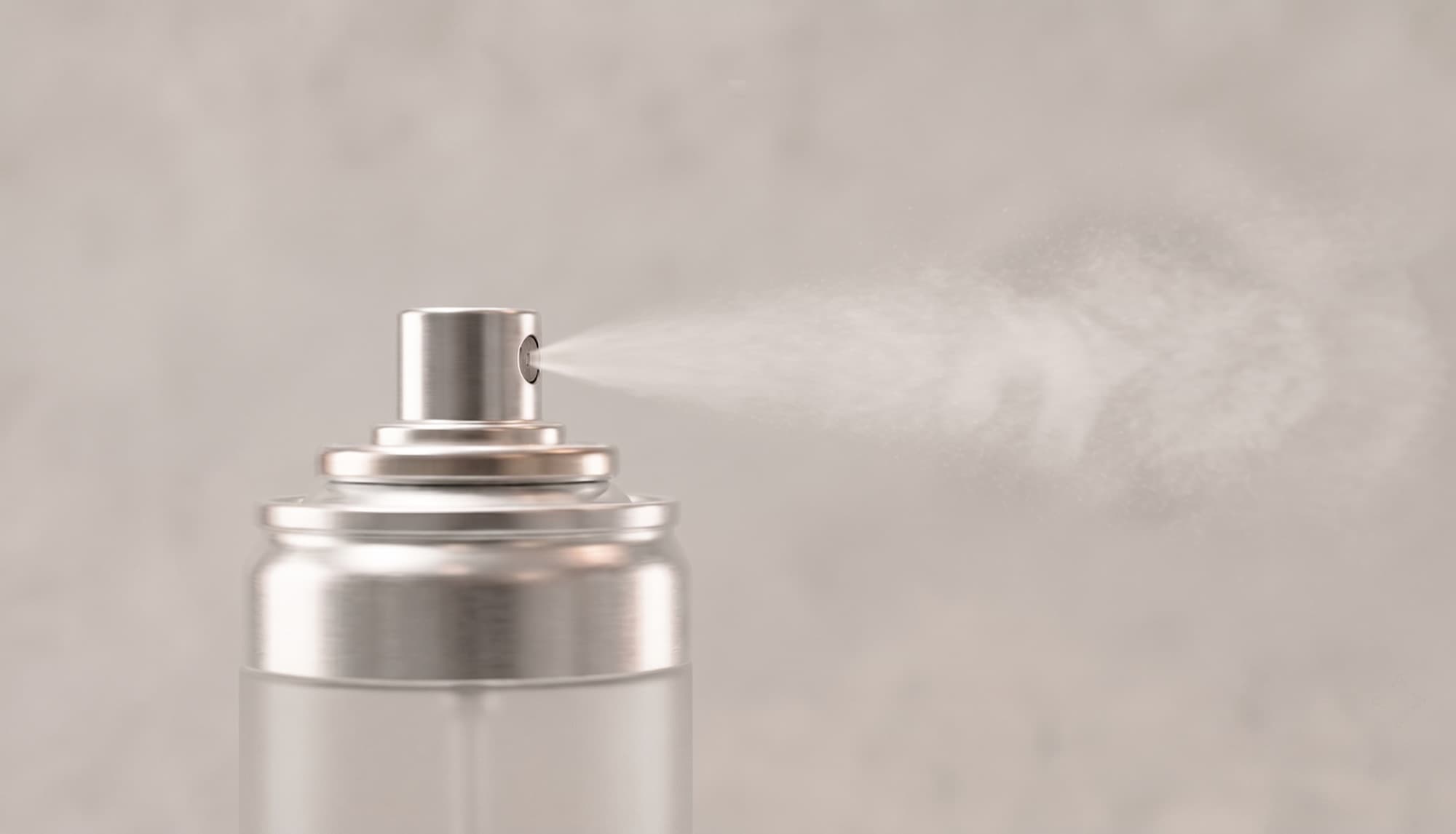 A fine mist releasing from the nozzle of an aluminium aerosol can