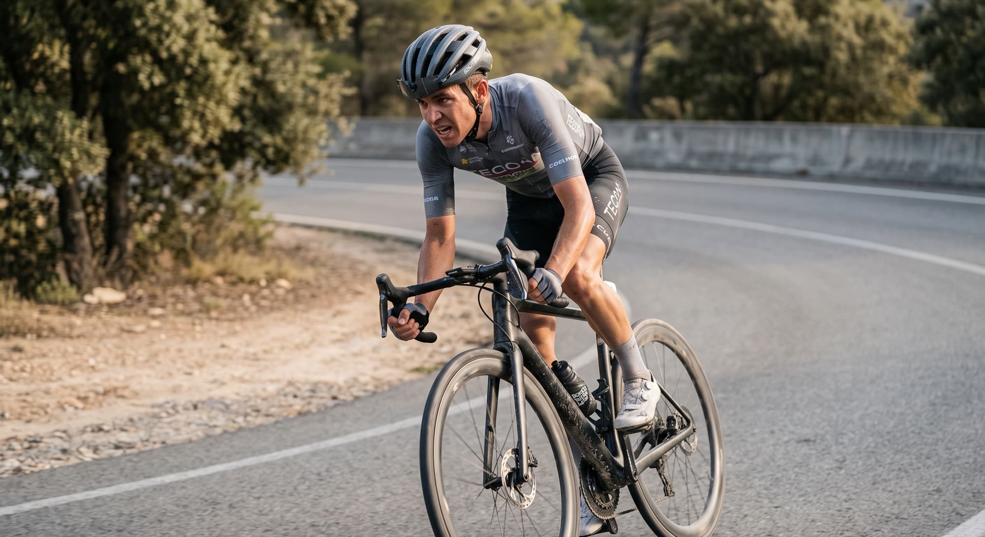 A road cyclist climbing out of the saddle in hot conditions